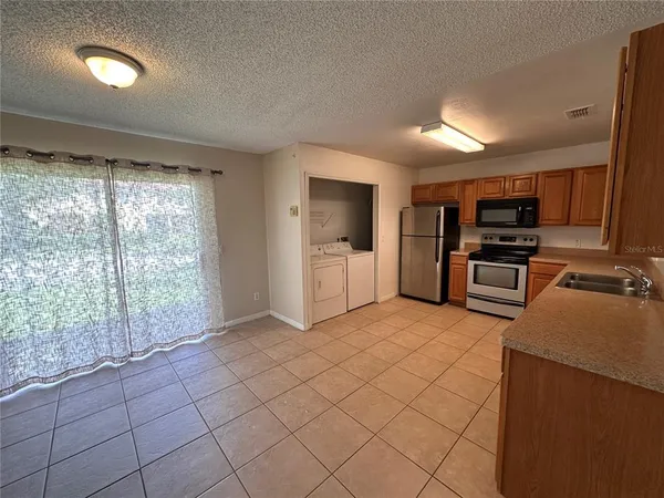 a kitchen with stainless steel appliances a refrigerator and a stove top oven