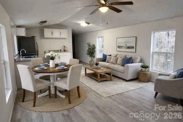 a living room with furniture and a chandelier