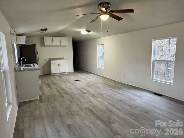 a view of a kitchen with a dishwasher cabinets and a wooden floor