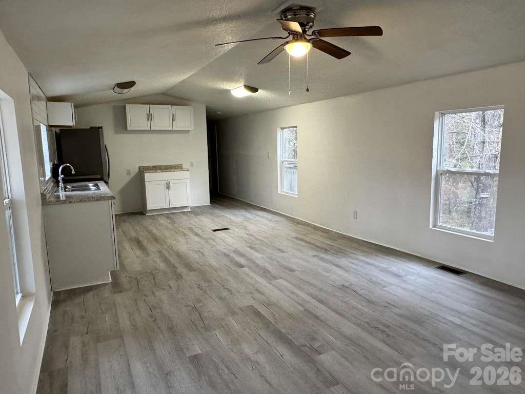 111 Cloverleaf Drive Clover, SC 29710 - Photo 3 of 13 a view of a kitchen with a dishwasher cabinets and a wooden floor