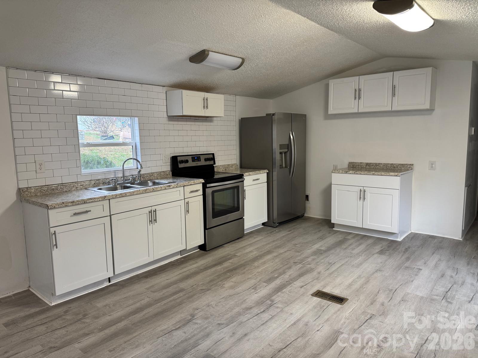 111 Cloverleaf Drive Clover, SC 29710 - Photo 4 of 13 a kitchen with a stove a sink and a refrigerator