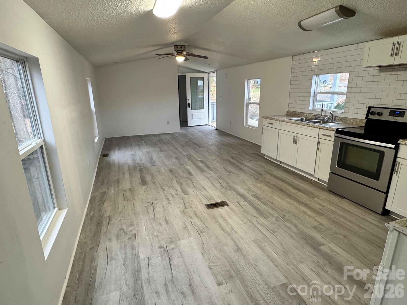 111 Cloverleaf Drive Clover, SC 29710 - Photo 5 of 13 a view of a kitchen with a sink cabinets and wooden floor