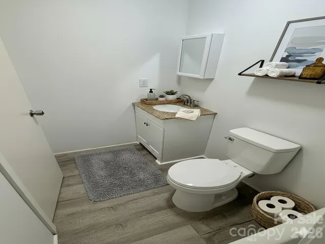 a bathroom with a toilet and a mirror