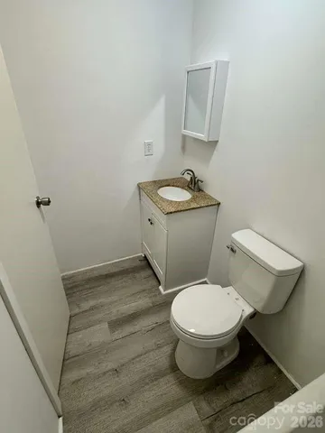 a white toilet sitting next to a bathroom sink