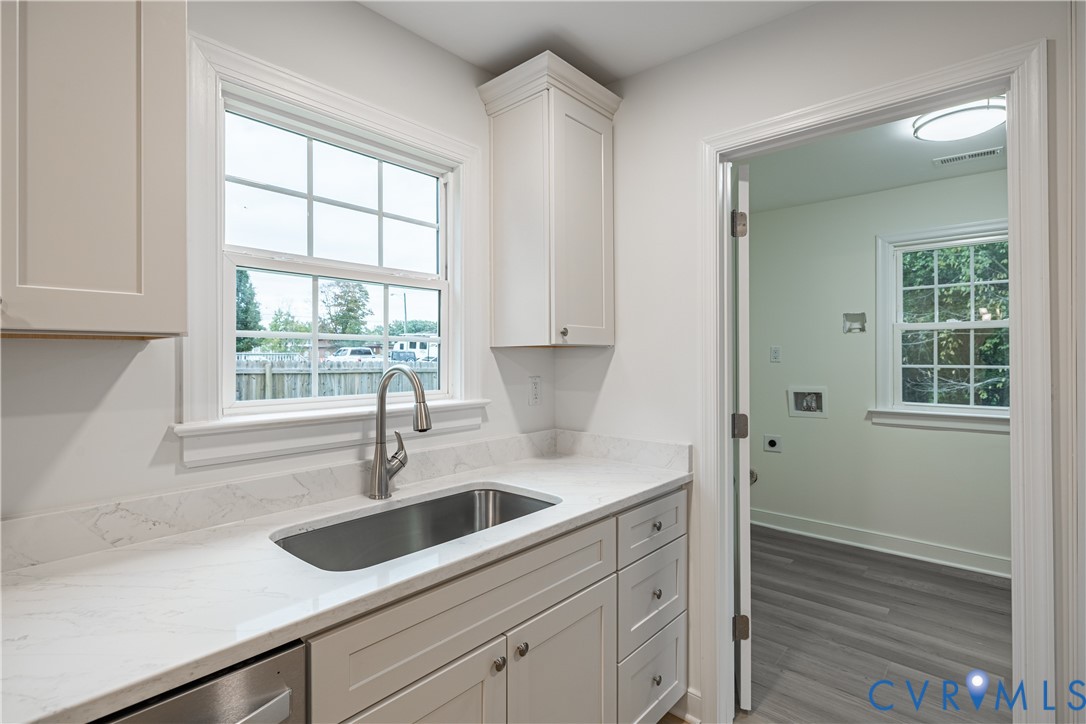 7709 Prairie Road Richmond, VA 23225 - Photo 8 of 37 Kitchen featuring light stone counters, white cabi