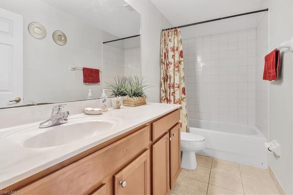 14130 Winchester Court, Unit 1503 Naples, FL 34114 - Photo 11 of 39 Full bathroom featuring tile flooring, shower / tub combo, toilet, and large vanity