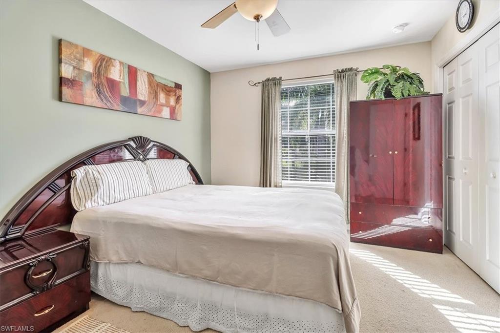 14130 Winchester Court, Unit 1503 Naples, FL 34114 - Photo 14 of 39 Carpeted bedroom with a closet and ceiling fan