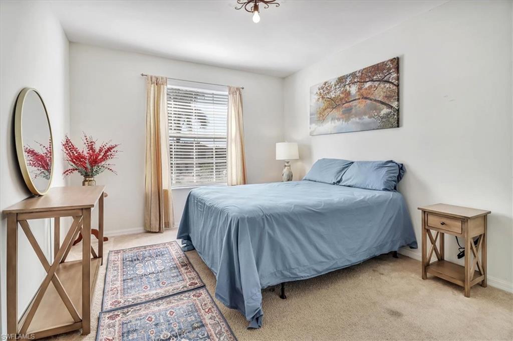 14130 Winchester Court, Unit 1503 Naples, FL 34114 - Photo 15 of 39 Bedroom featuring light carpet