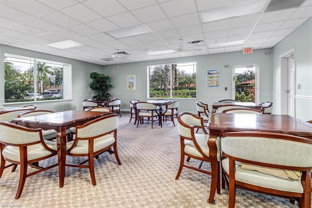 14130 Winchester Court, Unit 1503 Naples, FL 34114 - Photo 29 of 39 Dining space featuring a drop ceiling, ceiling fan, and light colored carpet