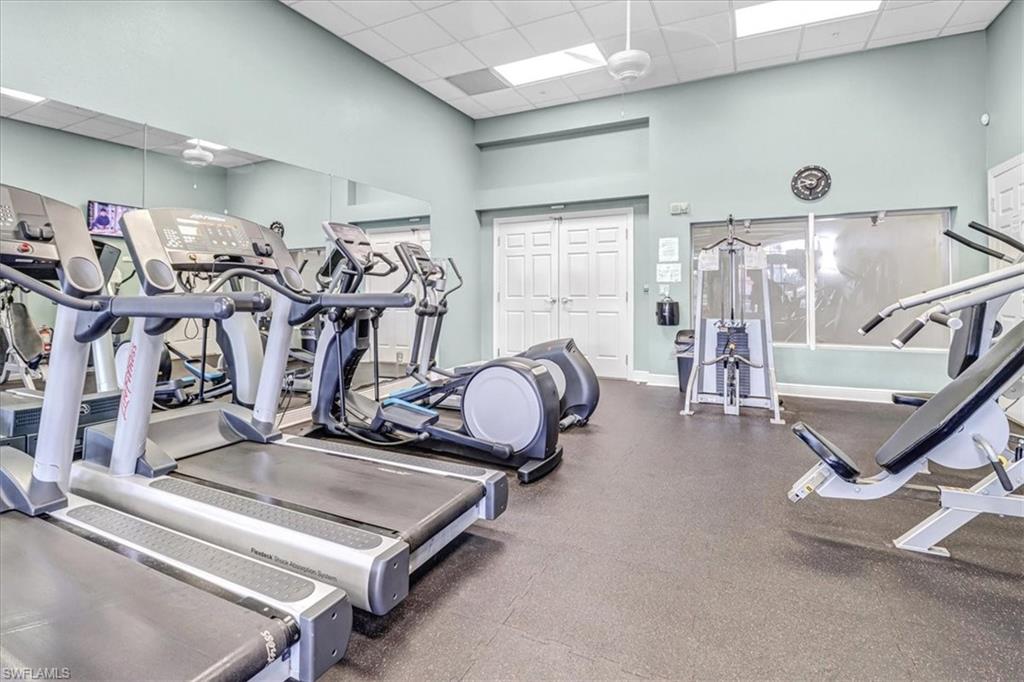 14130 Winchester Court, Unit 1503 Naples, FL 34114 - Photo 37 of 39 Exercise room featuring a towering ceiling and a drop ceiling