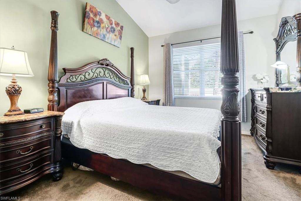 14130 Winchester Court, Unit 1503 Naples, FL 34114 - Photo 9 of 39 Carpeted bedroom featuring vaulted ceiling