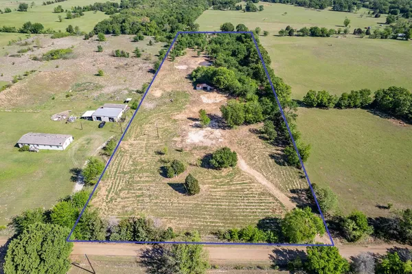 an aerial view of a house with a yard and lake view