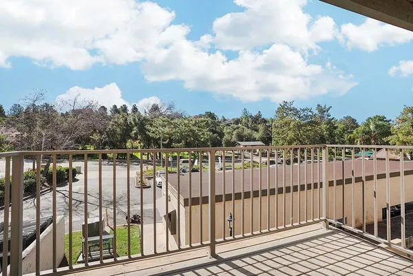 a view of a balcony with wooden fence