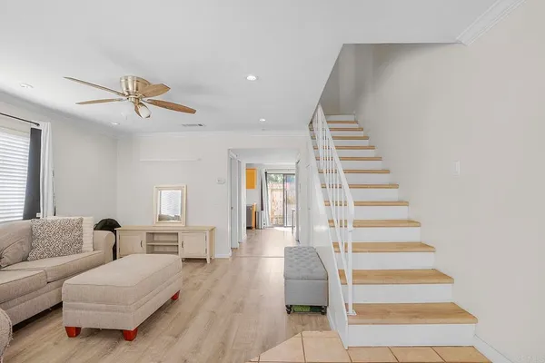 a living room with furniture and wooden floor