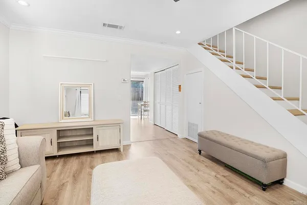 a living room with furniture and a stairs