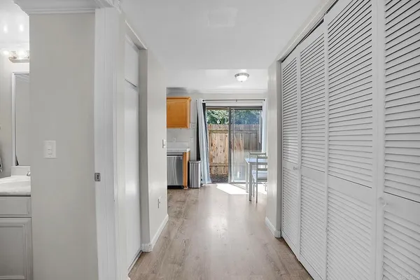 a view of a hallway with wooden floor