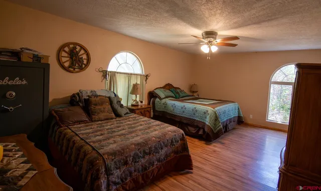 a bedroom with two beds and a chandelier