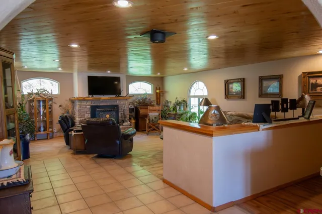 a living room with fireplace furniture and a flat screen tv