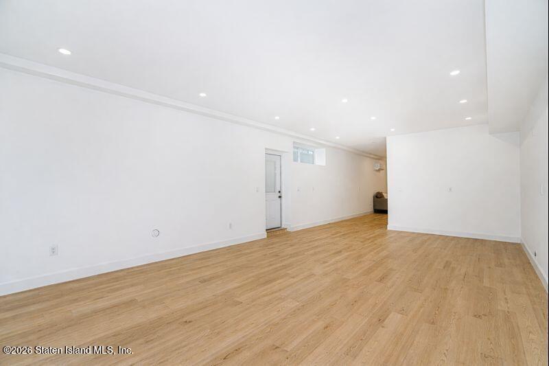 907 Rathbun Avenue Staten Island, NY 10309 - Photo 18 of 36 a view of an empty room with wooden floor