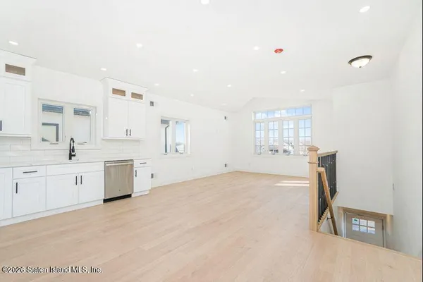a view of kitchen with sink and window