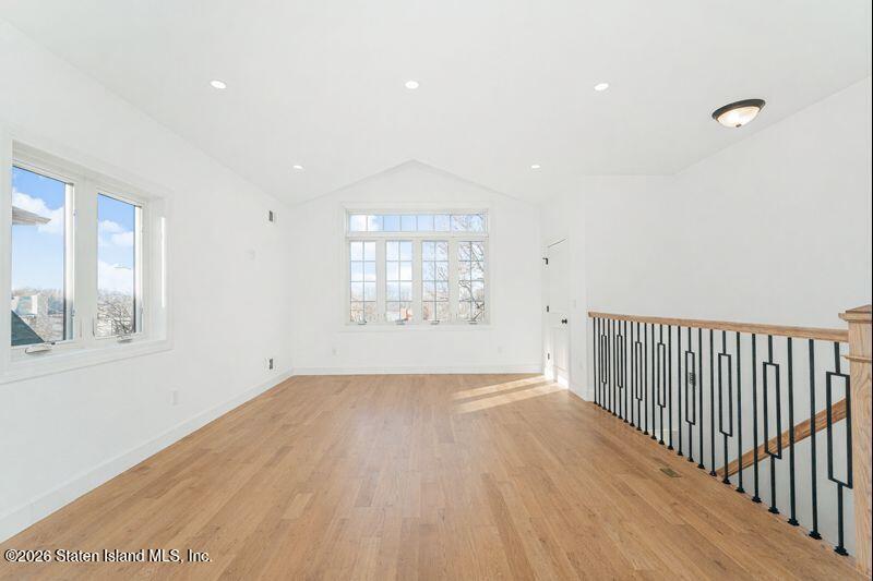 907 Rathbun Avenue Staten Island, NY 10309 - Photo 22 of 36 a view of an empty room with wooden floor and a window