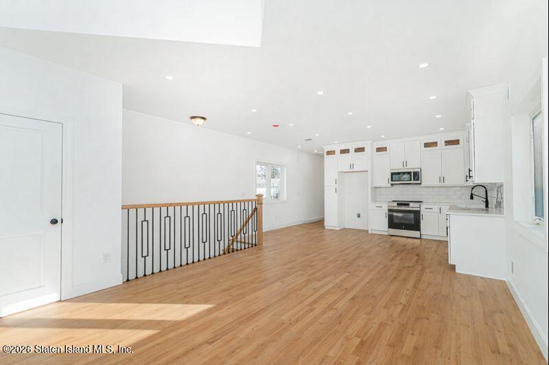 907 Rathbun Avenue Staten Island, NY 10309 - Photo 23 of 36 a view of a kitchen with a sink and dishwasher a refrigerator with wooden floor