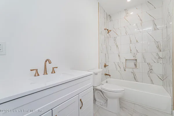 a bathroom with a sink a toilet and a bathtub