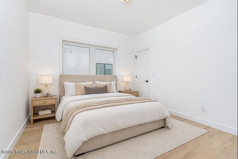 907 Rathbun Avenue Staten Island, NY 10309 - Photo 27 of 36 a large bed sitting in a bedroom next to a window