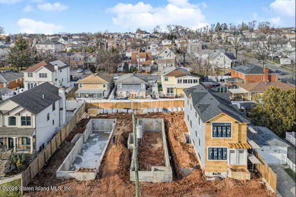 an aerial view of a residential apartment building with a yard