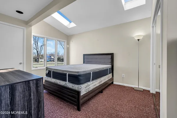 a bed room with a bed and a window