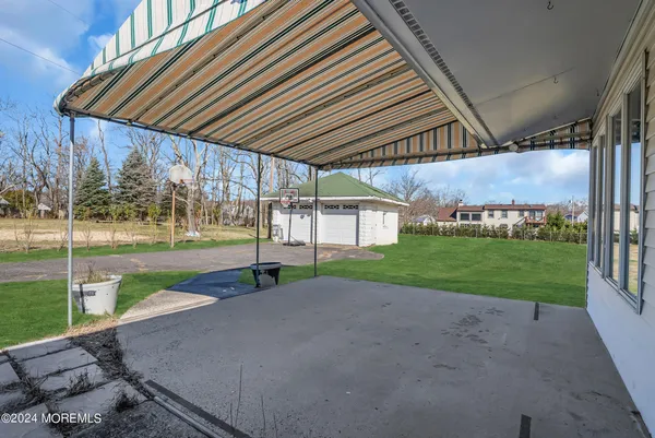 a view of a backyard with table and chairs