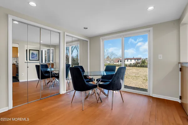 a dining room with furniture and wooden floor