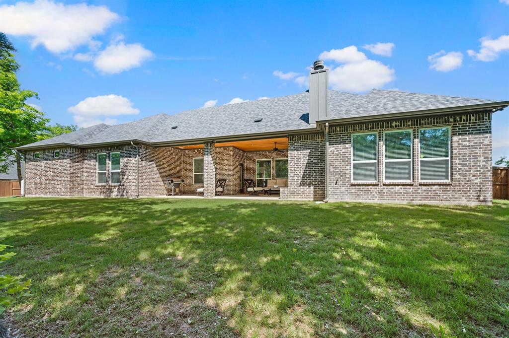 200 Clayton Crossing Springtown, TX 76082 - Photo 34 of 40 a front view of a house with a yard and garage