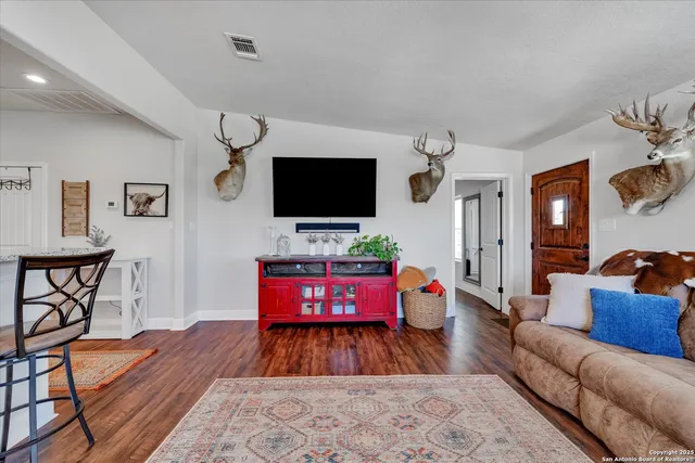 a living room with furniture ceiling fan and a rug