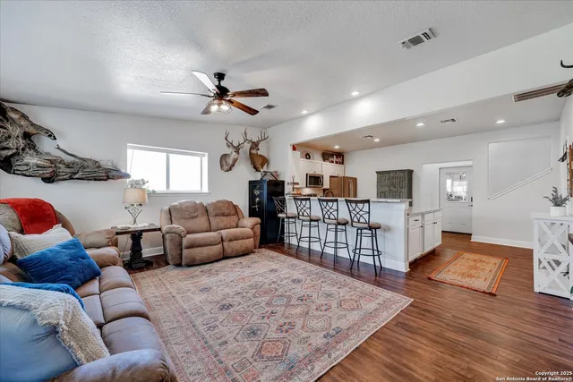 a living room with furniture or couch and a wooden floor