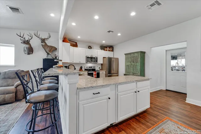 a kitchen with stainless steel appliances a refrigerator sink and cabinets