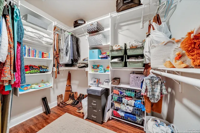 a view of a hallway with wooden floor and closet