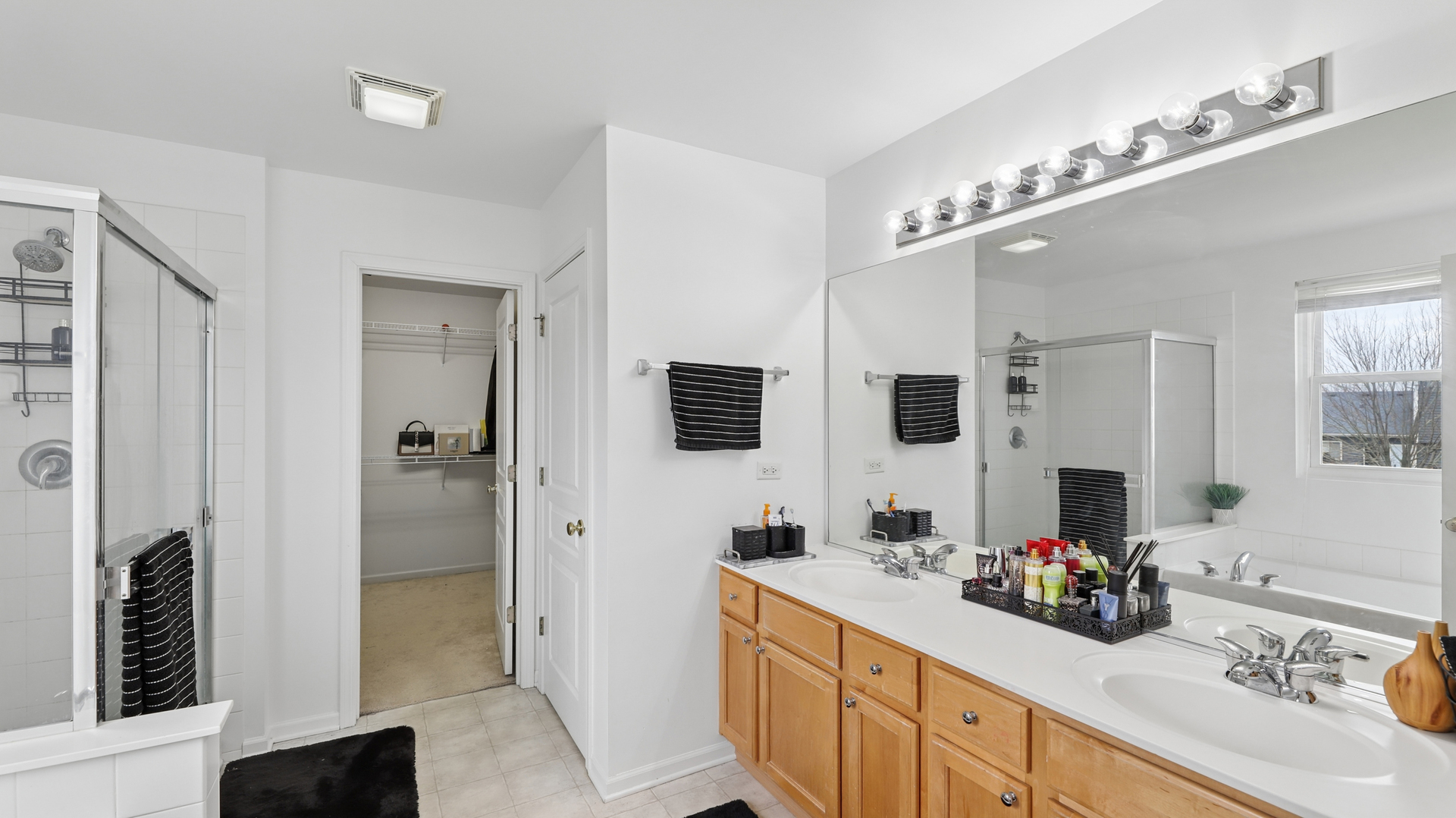 210 Honeysuckle Street Bolingbrook, IL 60490 - Photo 27 of 37 a bathroom with a double vanity sink a mirror and shower