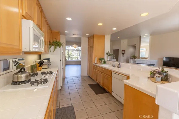 a large kitchen with stainless steel appliances lots of counter space and a sink