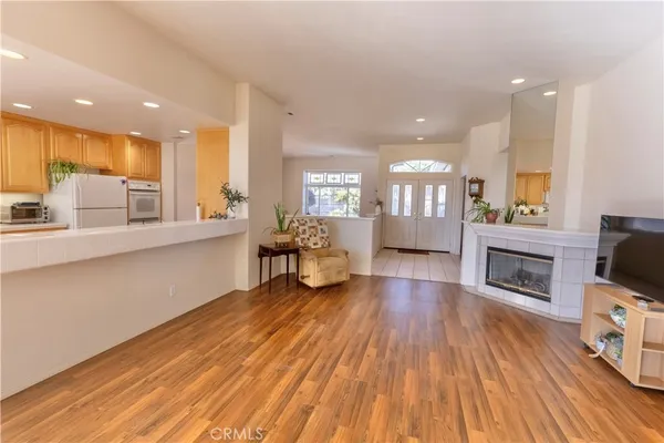 a living room with fireplace furniture and a wooden floor
