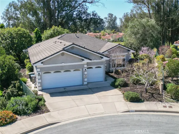 an aerial view of a house with a yard and potted plants