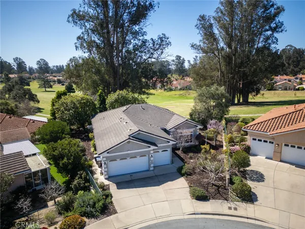 an aerial view of a house with garden space and street view