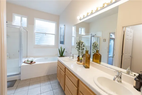 a bathroom with a tub sink and mirror