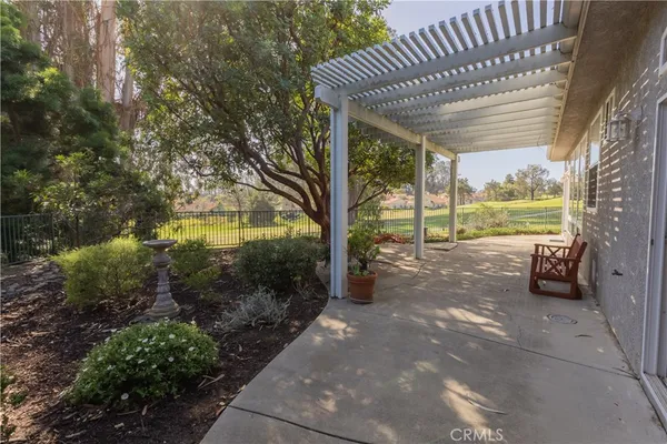 a view of a porch with furniture and garden