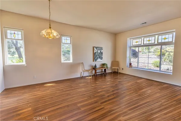 a view of a room with wooden floor and windows