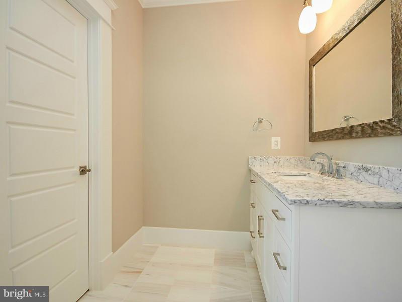 6000 27th Street North Arlington, VA 22207 - Photo 16 of 30 a bathroom with a granite countertop sink and a mirror