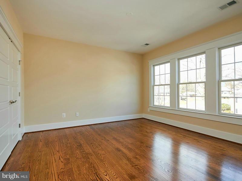 6000 27th Street North Arlington, VA 22207 - Photo 21 of 30 an empty room with wooden floor and windows