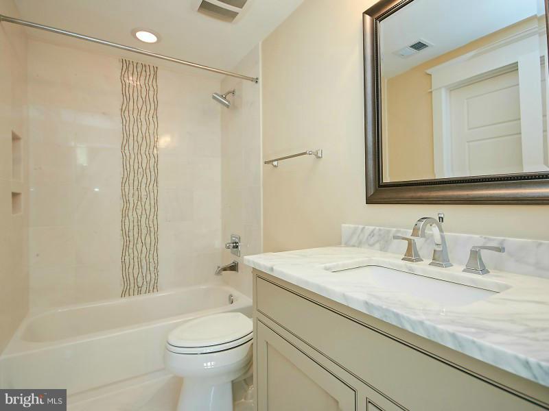 6000 27th Street North Arlington, VA 22207 - Photo 29 of 30 a bathroom with a sink a toilet and shower