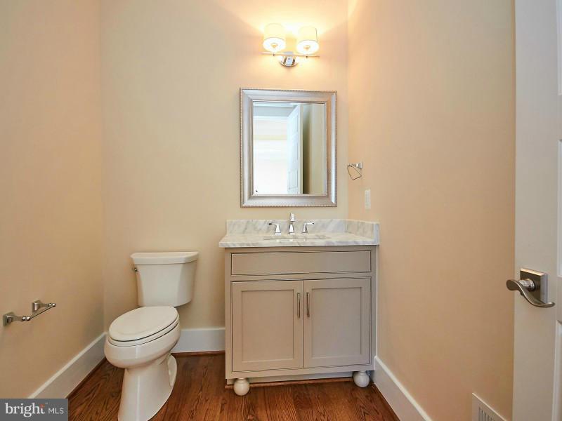 6000 27th Street North Arlington, VA 22207 - Photo 10 of 30 a bathroom with a toilet a sink and mirror