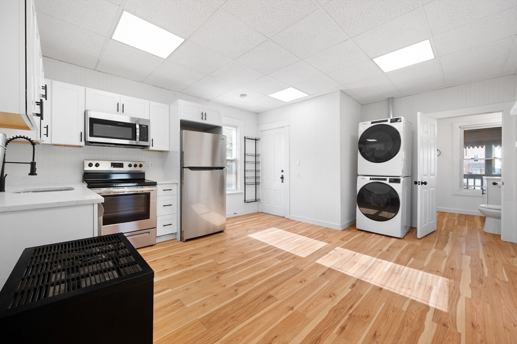 75 Gage Street, Unit 3 Worcester, MA 01605 - Photo 3 of 10 a kitchen with stainless steel appliances granite countertop a refrigerator stove and sink